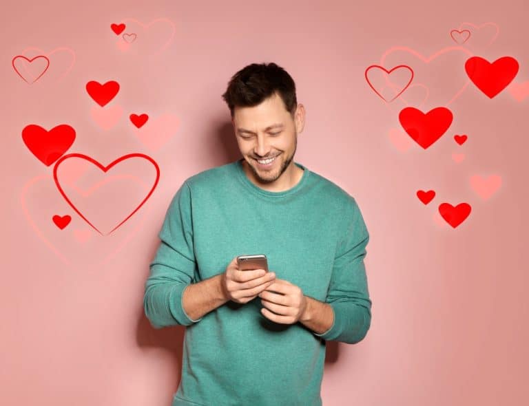 man smiling while using dating app