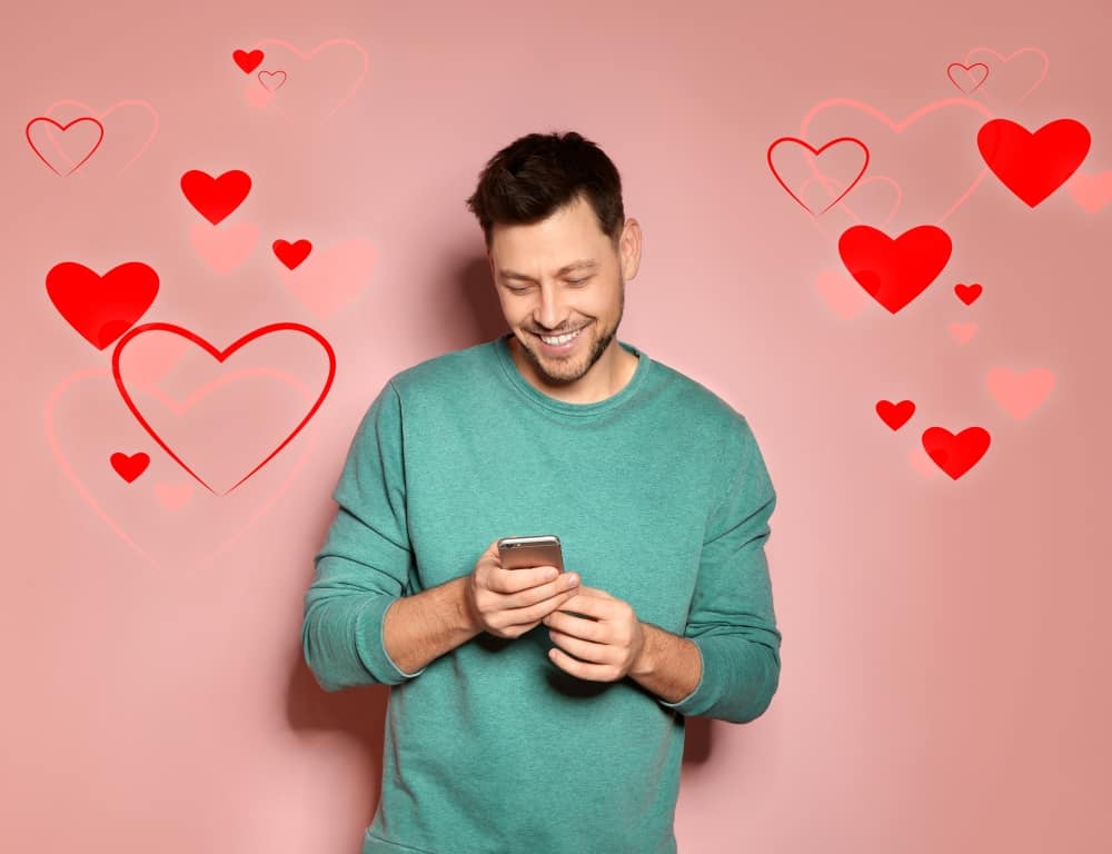 man smiling while using dating app