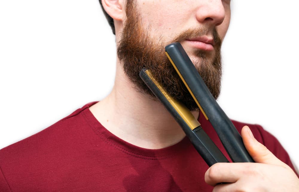 man straightened his beard with straightener, styling his beard