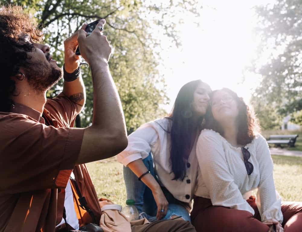 man taking photo with happy two girls