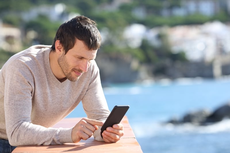 man texting while relax outdoor