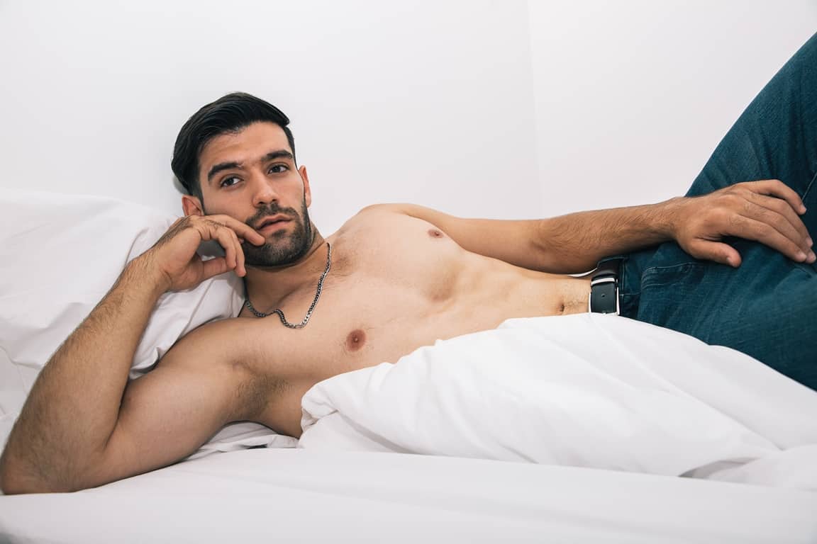 man thinking while laying on bed