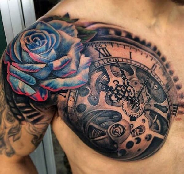Intricate tattoo of a blue rose and detailed clockwork gears on a person's upper chest and shoulder