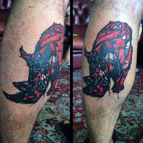 Man With Abstract Leg Calf Rhinoceros Tattoo
