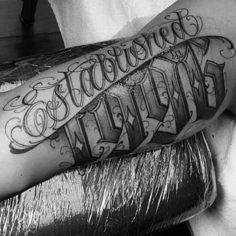 Man With Amazing Est 1996 Arm Tattoo With Script Design