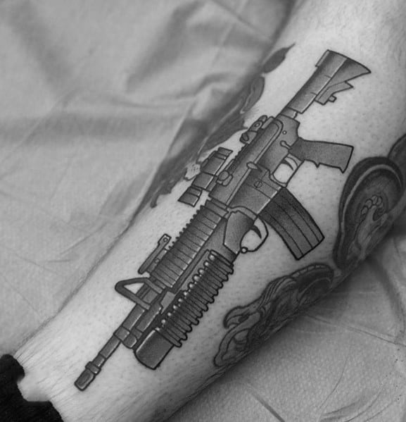 Black and grey AR-15 tattoo on the forearm, featuring bold outlines and shading, symbolizing strength, precision, and firearm appreciation.