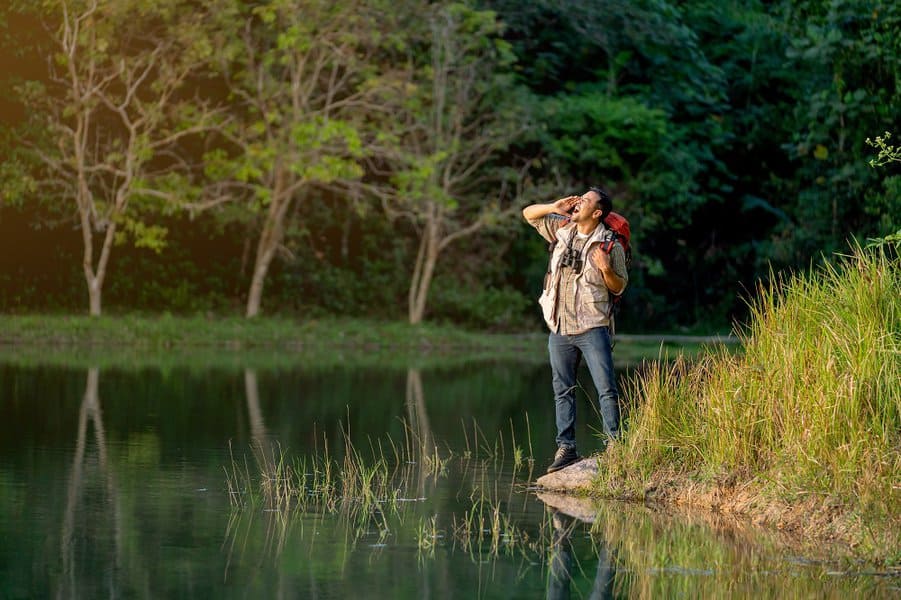 man with bagpack shouting during camping