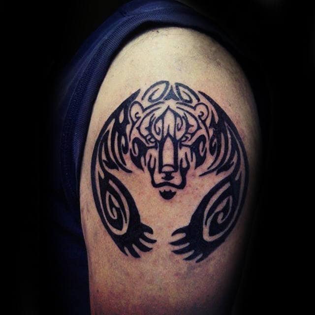 Man With Bear Claw Upper Arm Tattoo Tribal Designs