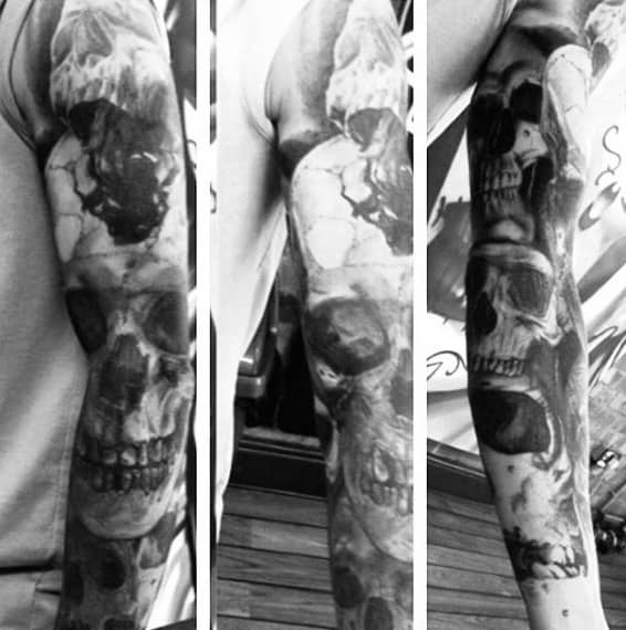 Man With Black And Grey Skull Sleeve Tattoos
