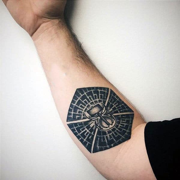 Man With Black Ink Pattern Hammer Tattoon On Inner Forearm