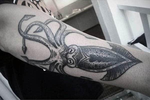 Man With Black Squid Tattoo On Outer Forearm