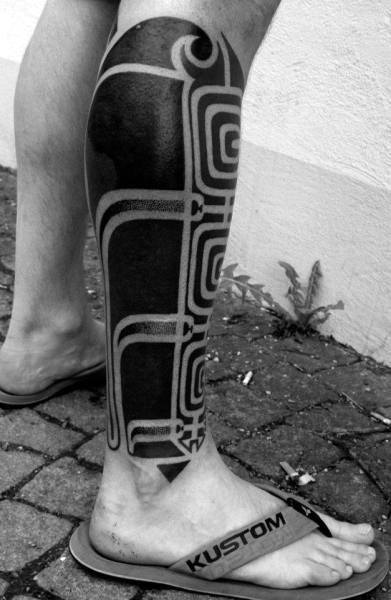 Man With Blackwork Tribal Leg Tattoo Negative Space Design