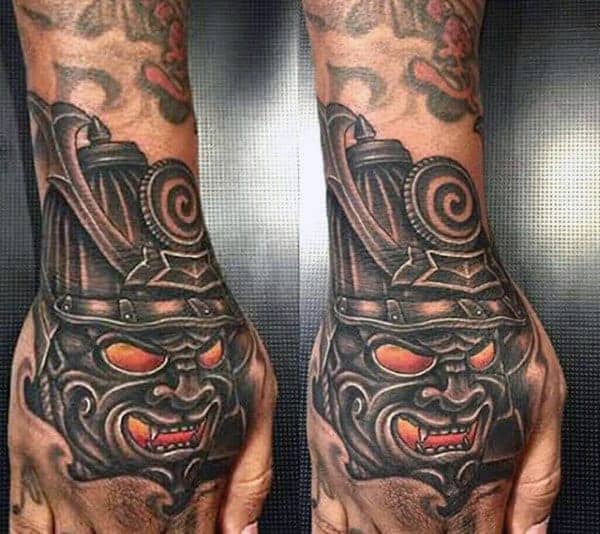 man-with-bold-samurai-mask-hand-tattoo
