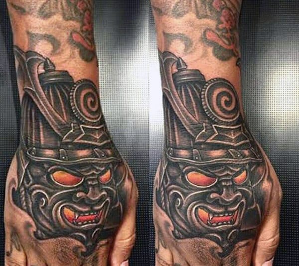 Man With Bold Samurai Mask Hand Tattoo