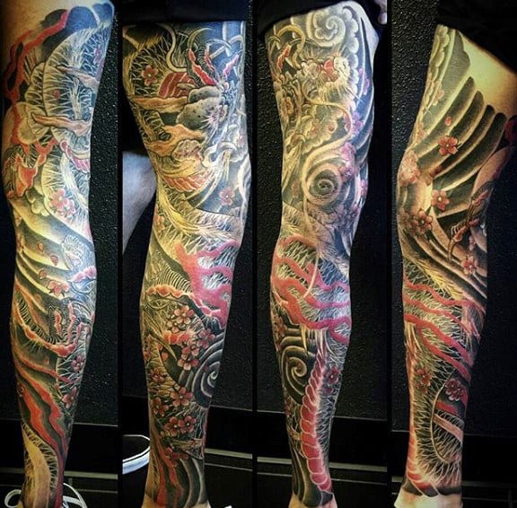Full-leg Japanese-style tattoo featuring a vibrant red and gold dragon intertwined with cherry blossoms and swirling clouds