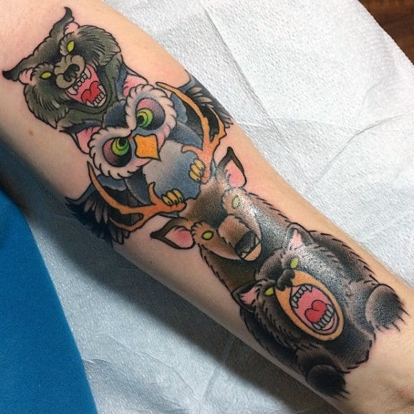 Man With Catroon Animal Totem Pole Forearm Tattoo