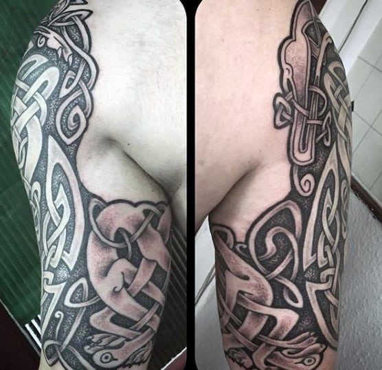 Intricate black and grey Celtic knot tattoo on an upper arm and bicep