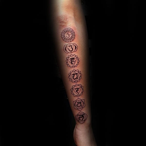 Man With Chakras Tattoo On Outer Forearms