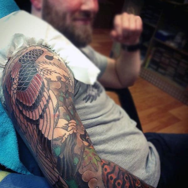 Man With Colorful Hawk Half Sleeve Tattoo