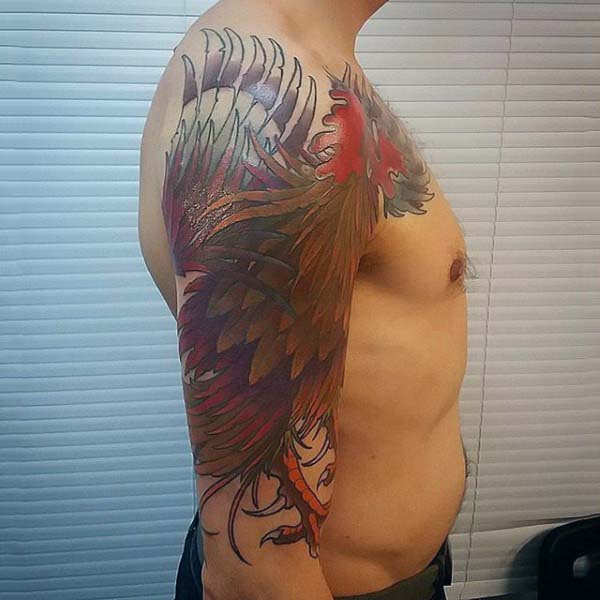 Man With Colorful Rooster Tattoo On Upperarm