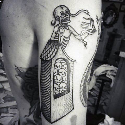 Black ink tattoo of a skeleton standing guard above a tower filled with skulls on an arm