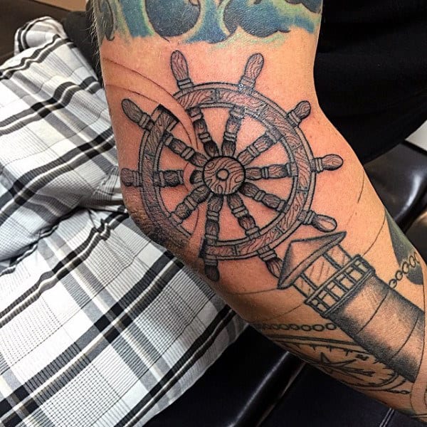 Man With Cool Ship Wheel Tattoo Design On Arm