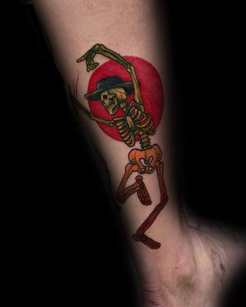 Colorful dancing skeleton tattoo with a black hat, dynamic pose, and a bold red background, creating a striking and lively design.