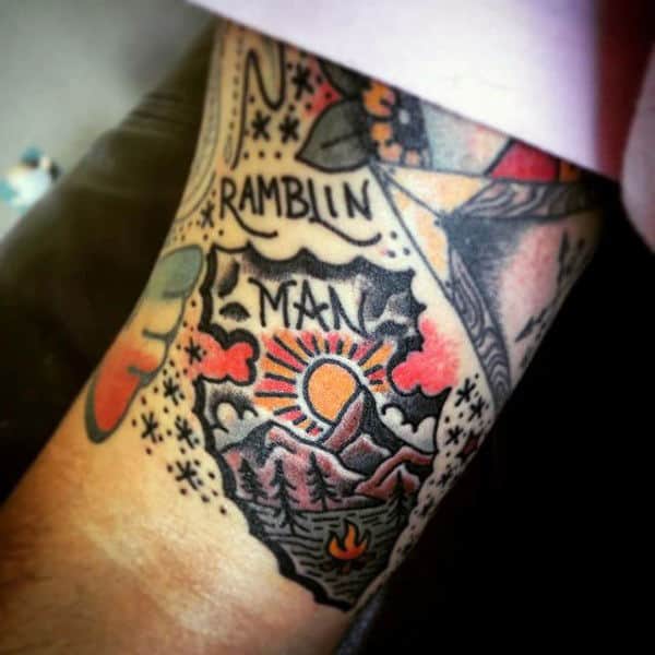 Man With Decorative Arrrowhead Tattoo On Upper Arms