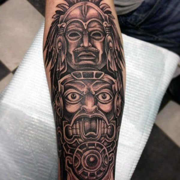 Man With Detailed Black Work Totem Pole Forearm Tattoo