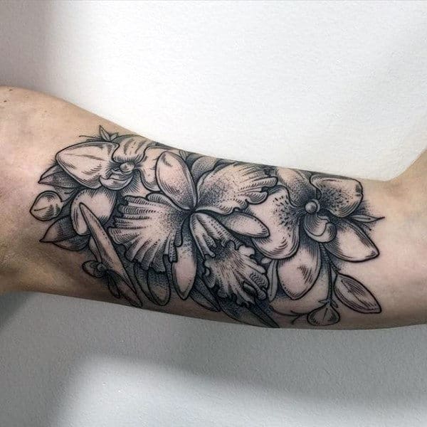 Man With Detailed Orchid Inner Arm Bicep Tattoos