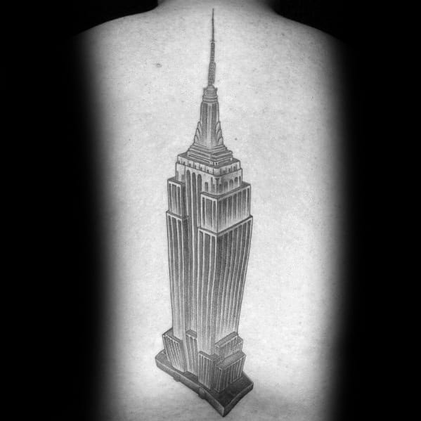 Bold Empire State Building tattoo, inked in sharp black lines and detailed shading, centered on a man's back.