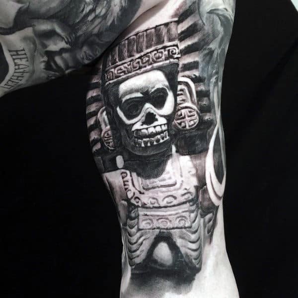 Man With Ethnic Idol Tattoo On Quarter Sleeves