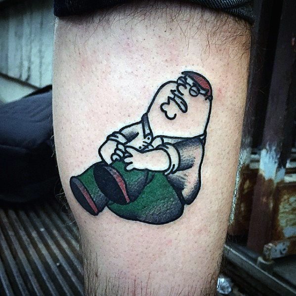 Tattoo of Peter Griffin from Family Guy sitting on the ground, holding his knee in pain, referencing his iconic "Ahhh" scene from the show.