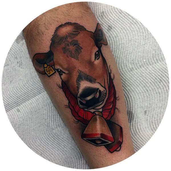 Bold color tattoo of a brown cow with a red collar and large bell, featuring a tag marked “59” in its ear.