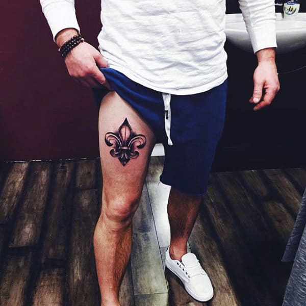 Man With Fleur De Lis Thigh Tattoo