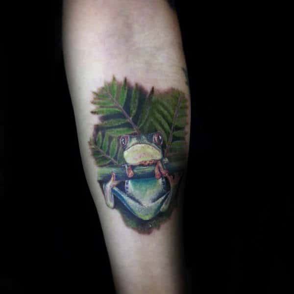 Man With Frog And Leaves Tattoo On Inner Forearm