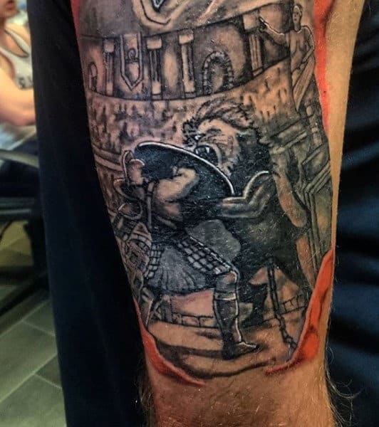 Detailed gladiator tattoo with a fierce fight scene involving a lion on a person's arm