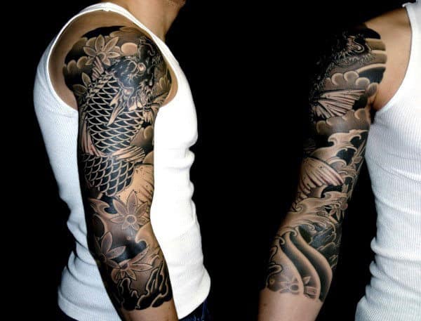 Man with detailed full sleeve koi fish tattoo on his left arm