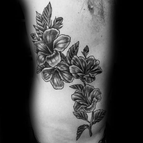 Man With Hibiscus Flowers Tattoo On Rib Cage Side Of Body
