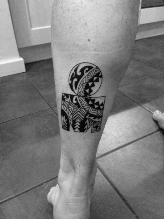 Tattoo combining the Ironman logo with intricate tribal patterns, incorporating ocean waves and geometric elements, symbolizing endurance and cultural significance.