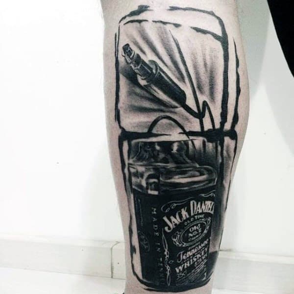 Man With Jack Daniels Watercolor Headphone Cord Tattoo On Leg