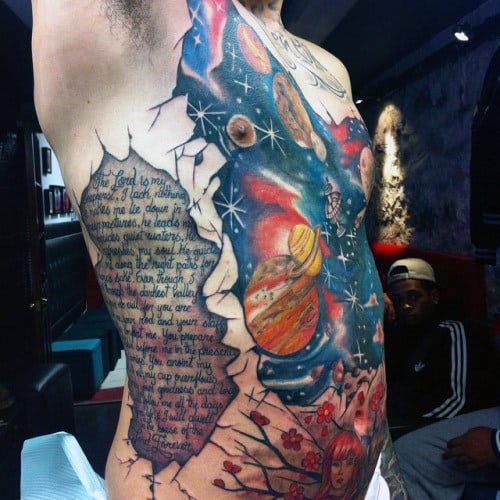 Man With Literary Work And Universe Tattoo On Torso