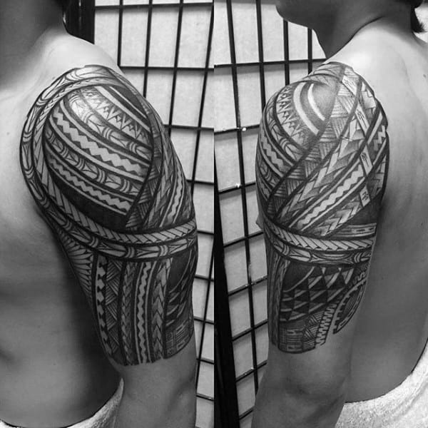 Man With Looped Half Sleeve Tribal Tattoo