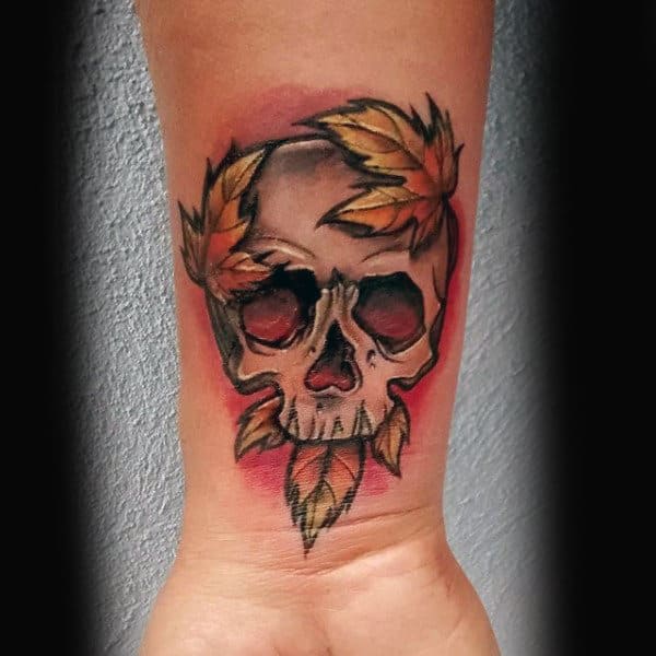 Man With Maple Leaf Skull Tattoo On Wrist