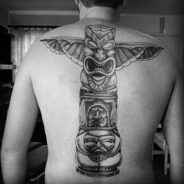 Man With Menacing Totem Pole Black Work Back Tattoo