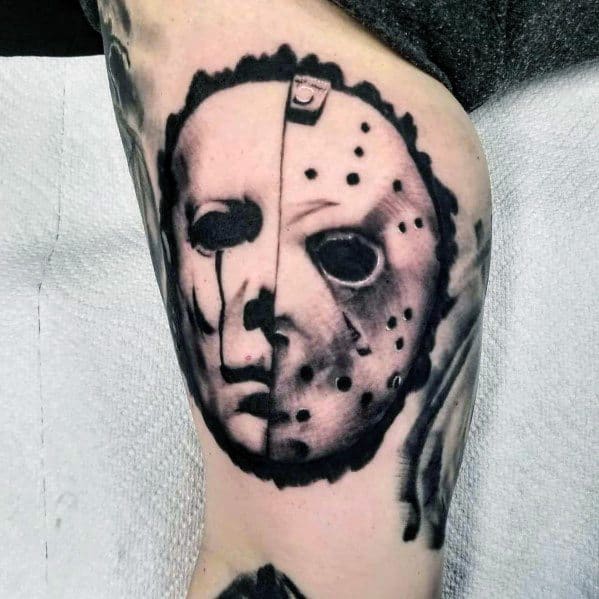 Black and grey tattoo blending Michael Myers and Jason Voorhees masks, creating a haunting horror fusion design.