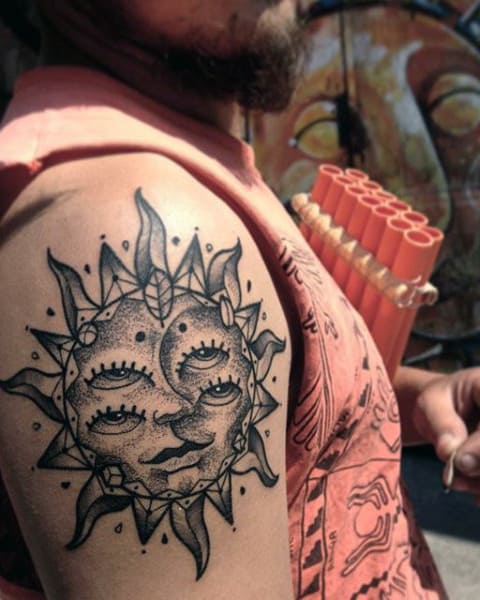 Man With Multiple Eye Sun Tattoo On Upper Arm