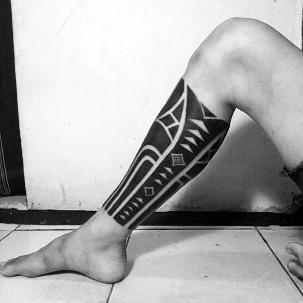 Man With Negative Space Shapes Leg Sleeve All Black Ink Tattoo