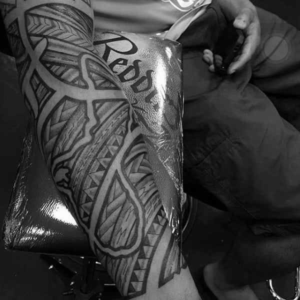 Man With Negative Space Tribal Polynesian Forearm Sleeve Tattoo