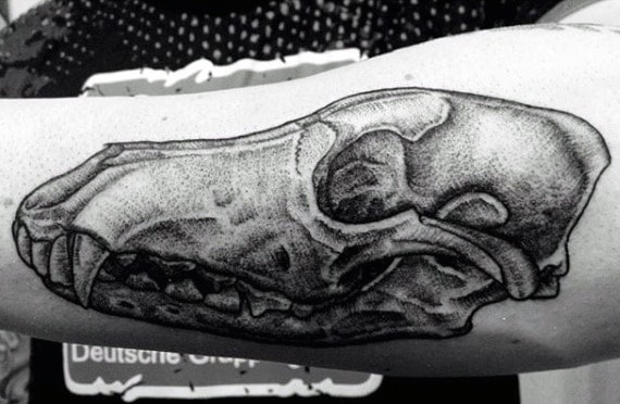 Man With Outer Forearm Tattoo Of Wolf Skull